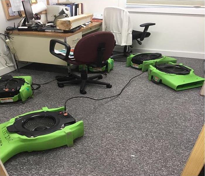 Air movers placed strategically on the floor of an office 