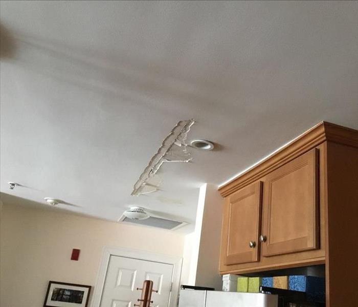 Water-damaged drywall on the ceiling in a kitchen