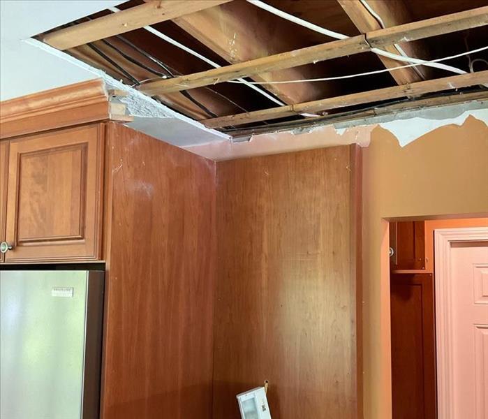 Ceiling near kitchen cabinet cut away with clean, dry joists