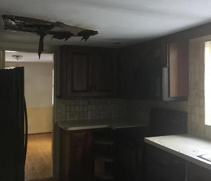 Water damaged hole in the ceiling of a kitchen