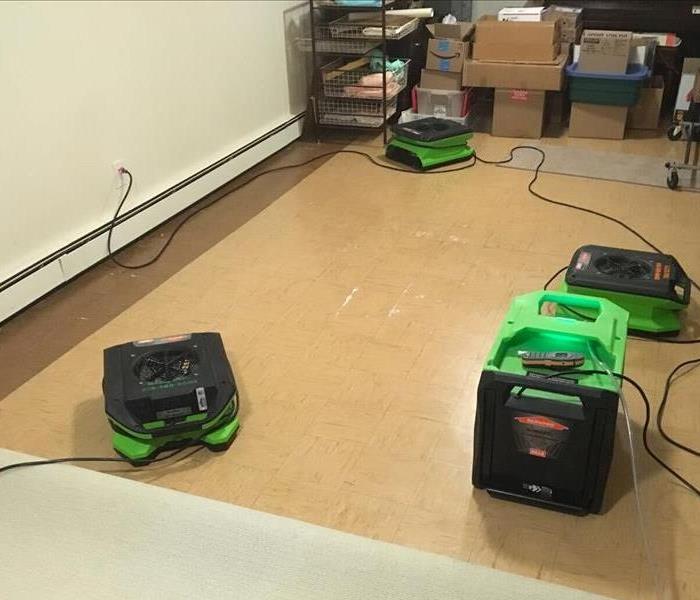 Air movers and dehumidification equipment deployed in an office with vinyl tile flooring
