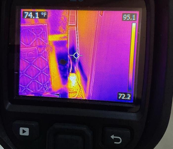 Closeup of a thermal imaging camera reading near HVAC 
