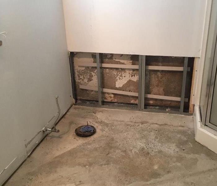 Bathroom with toilet and flooring removed due to water damage from toilet over flowing