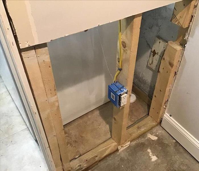 Inside a house where drywall has been removed to dry saturated wood studs