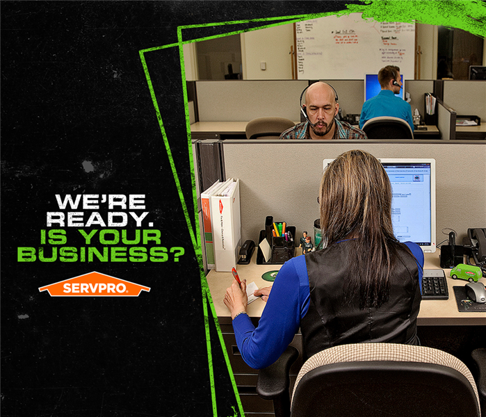 Image of SERVPRO office staff answering calls with caption: WE