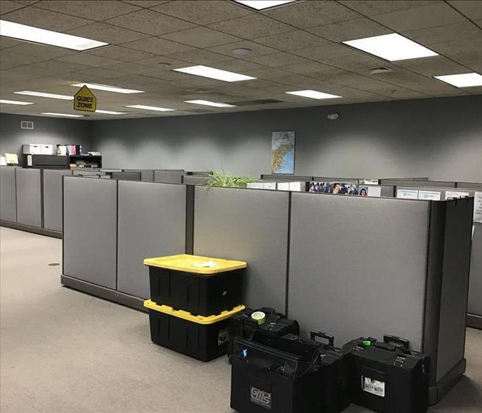 black containers stacked by office cubicles