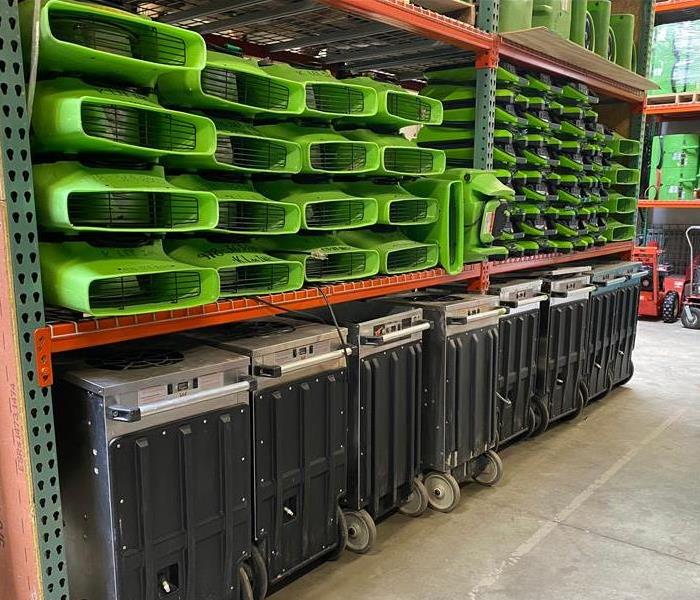 SERVPRO equipment on shelves in a warehouse. 